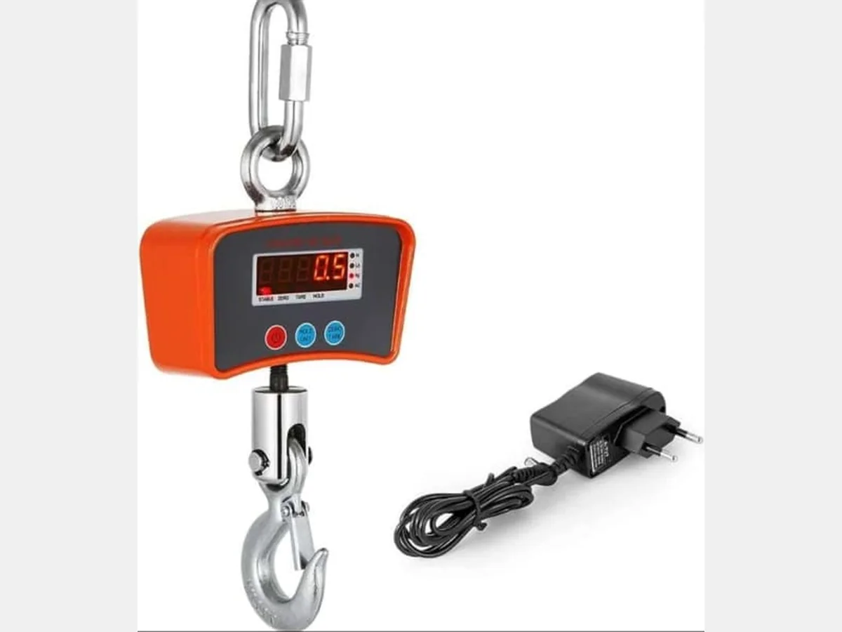 Hanging Scale 500 Orange digital hanging crane scale with red LED display, shackle and steel hook, shown with its charger