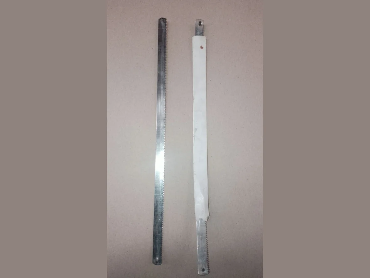 Manual Blades Two straight manual butchery saw blades with fine teeth and mounting holes at each end