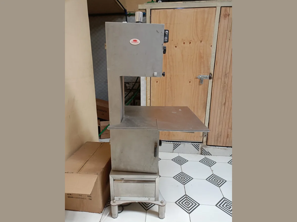 Bonesaw 300 Tall stainless steel bone saw machine standing in the shop, with cutting table and side controls