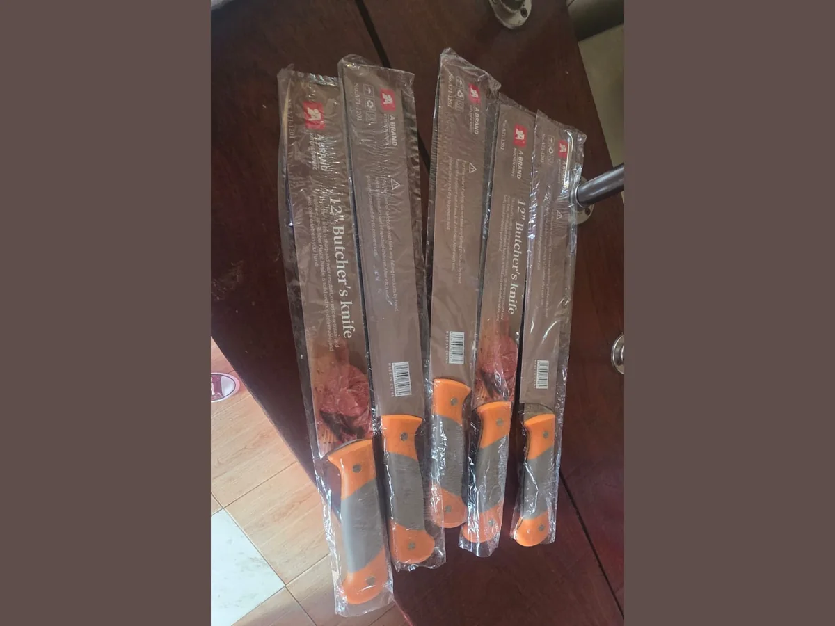 Packaged 12 inch butcher's knives with orange and grey handles Packaged 12 inch butcher's knives with orange and grey handles